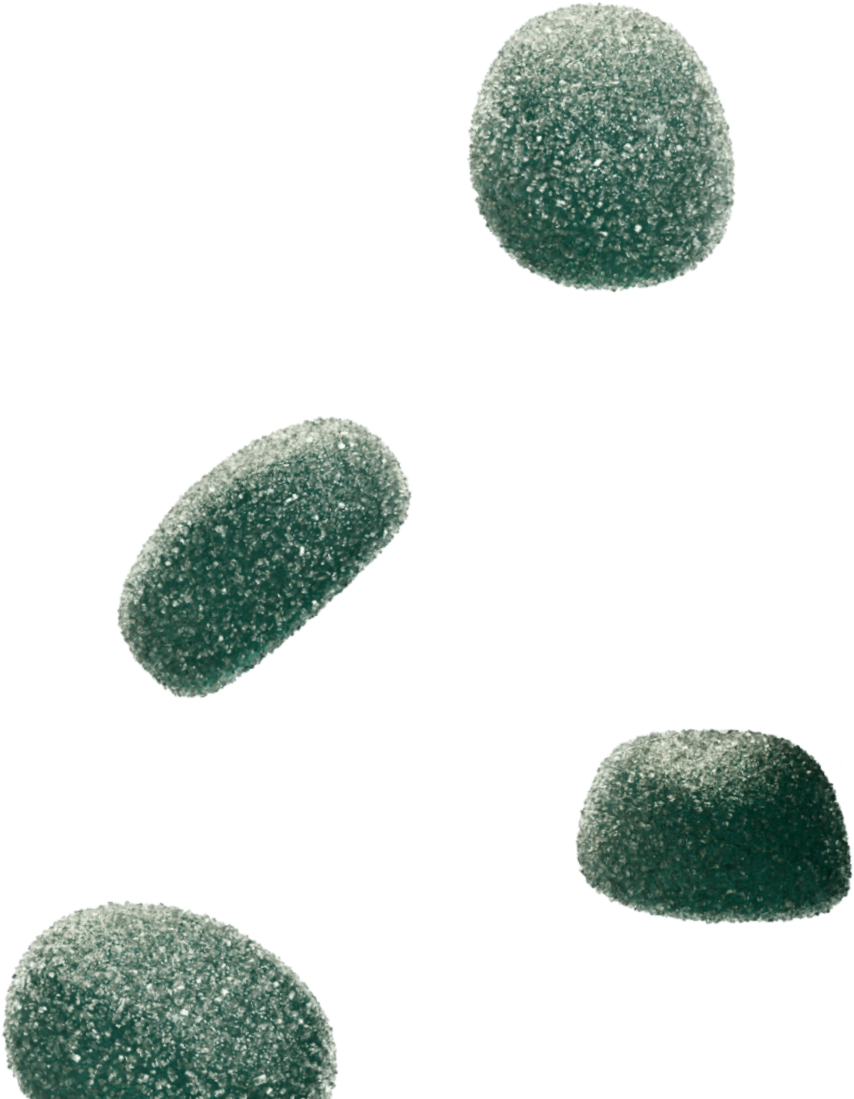 Four green sugar-coated gumdrop candies scattered on a transparent background